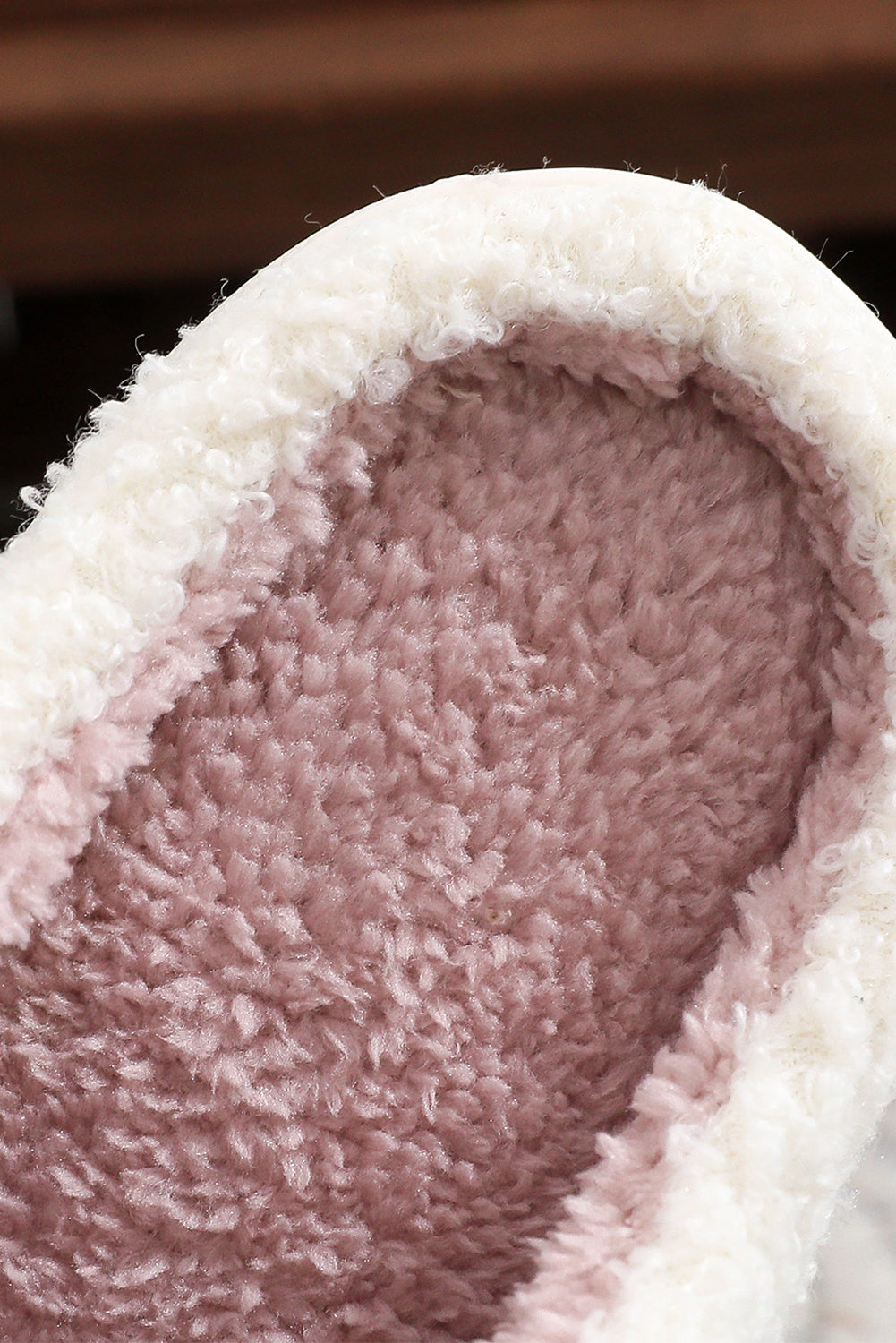 Close-up of a fluffy white and pink slipper