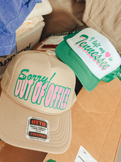 Two hats with text on a cardboard surface