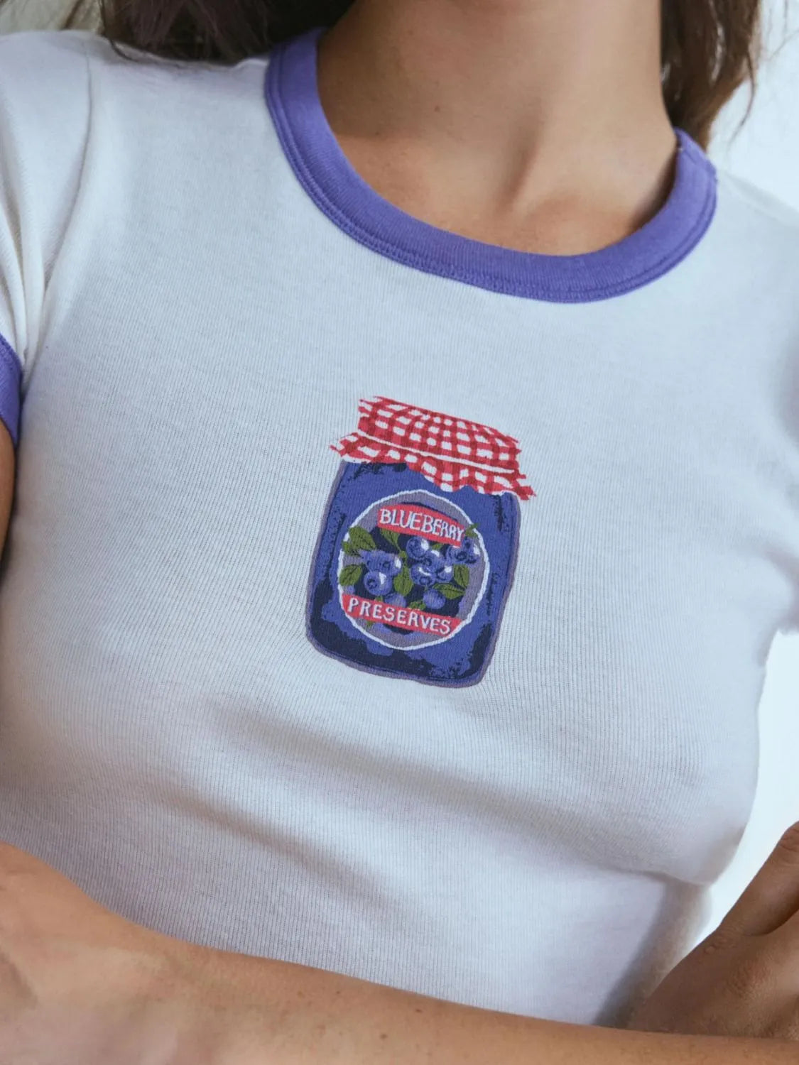lavender ringer baby tee with vintage-style blueberry preserves print on the front.