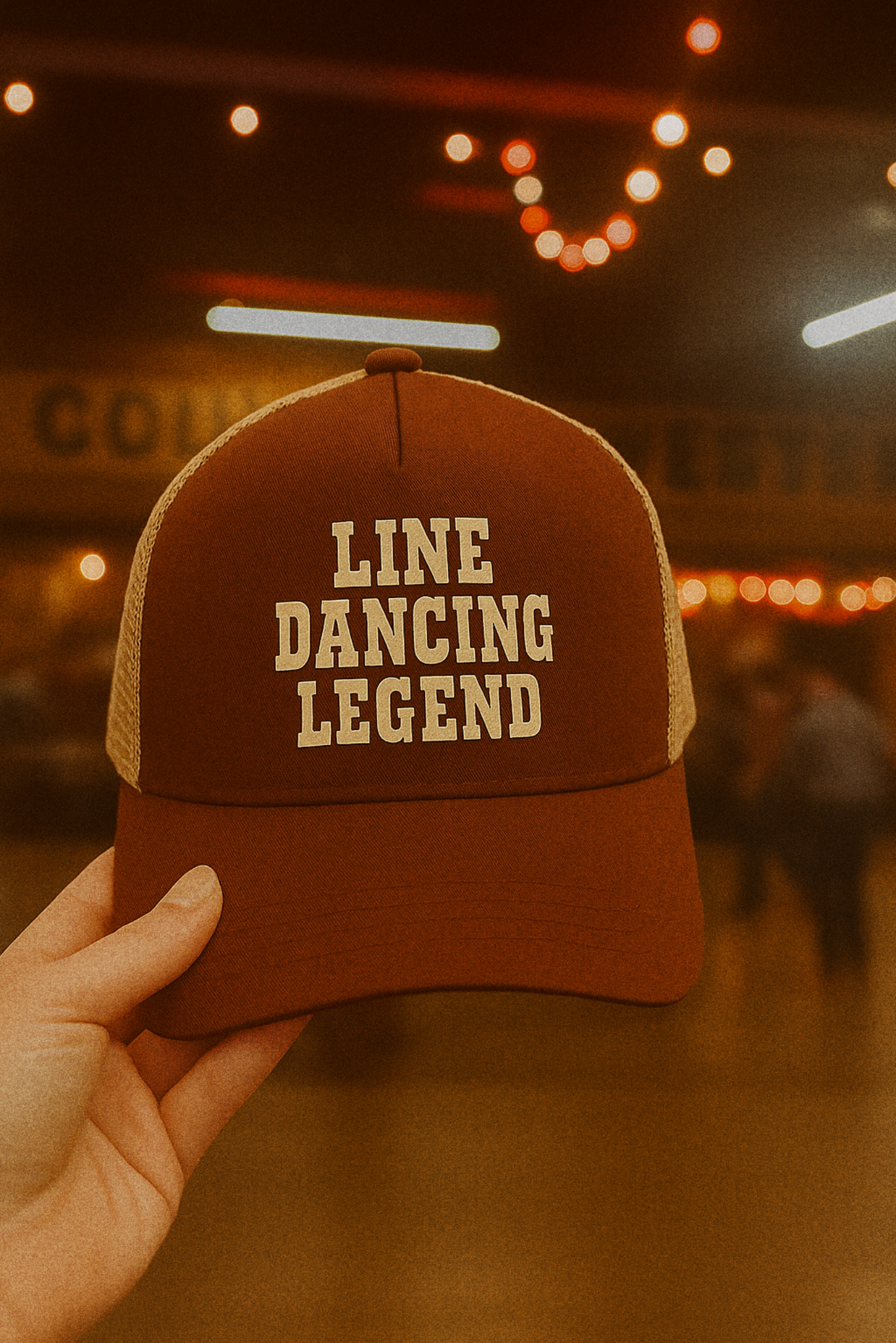 A brown and tan trucker hat with cream "Line Dancing Legend" text, styled for country music lovers and line dancers.