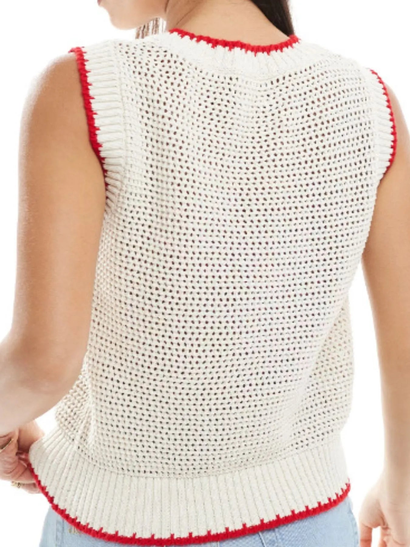 White knitted vest with red trim worn by a person