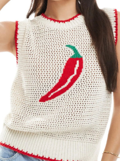 Person wearing a white sleeveless sweater with a red chili pepper design.